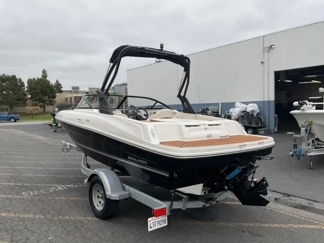 Slide: The Image of 2020 Bayliner VR4 Bowrider I/O on trailer, parked outside a building. - 5