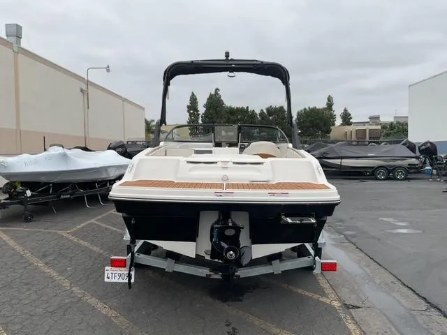Slide: The Image of 2020 Bayliner VR4 Bowrider I/O boat parked in a lot, rear view. - 6