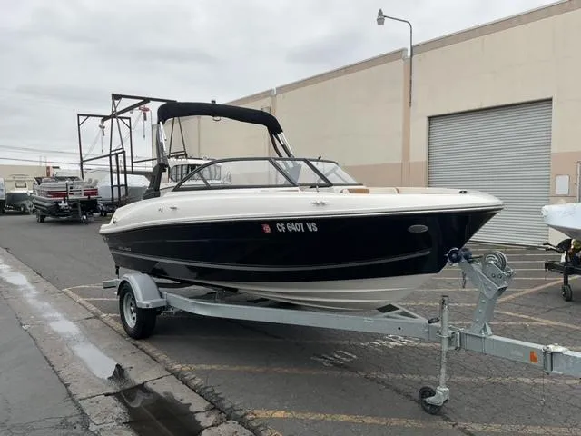 Slide: The Image of 2020 Bayliner VR4 Bowrider I/O on trailer in industrial setting. - 7