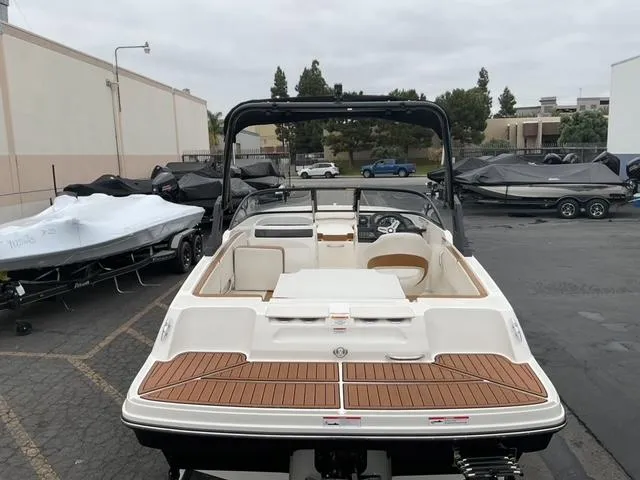 Slide: The Image of 2020 Bayliner VR4 Bowrider I/O boat in a parking lot, rear view. - 9
