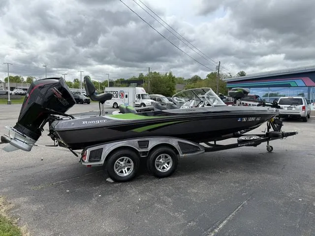 Slide: The Image of 2020 Ranger 212LS boat on trailer, parked outdoors under cloudy sky. - 7