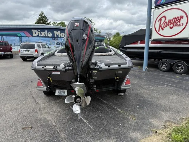 Slide: The Image of 2020 Ranger 212LS boat with outboard motor in a parking lot. - 8