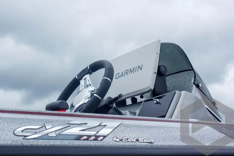 Slide: The Image of 2025 Caymas CX 21 PRO boat dashboard with Garmin navigation system, steering wheel, and logo. - 14