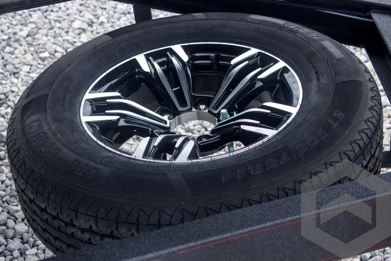 Slide: The Image of 2025 Caymas CX 21 PRO trailer wheel on gravel surface. - 18