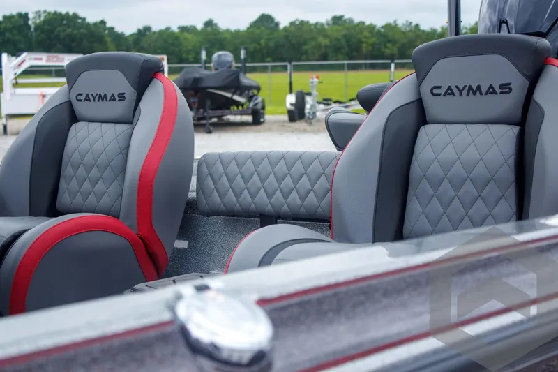 Slide: The Image of 2025 Caymas CX 21 PRO boat seats with gray and red upholstery, featuring diamond stitching. - 21