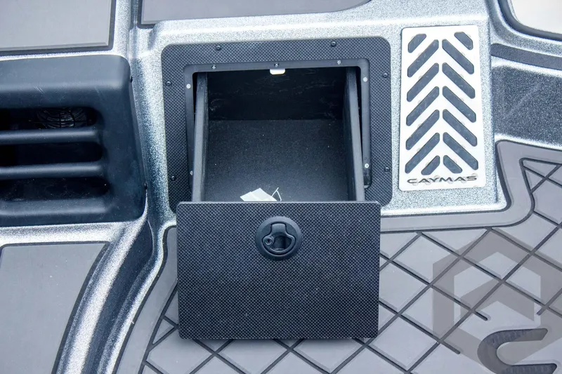 Slide: The Image of 2025 Caymas CX 21 PRO boat storage compartment with open hatch and textured flooring. - 25