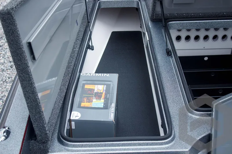 Slide: The Image of 2025 Caymas CX 21 PRO storage compartment with Garmin electronics box inside. - 26