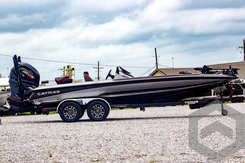 Slide: The Image of 2025 Caymas CX 21 PRO boat on trailer, parked outdoors under cloudy sky. - 4