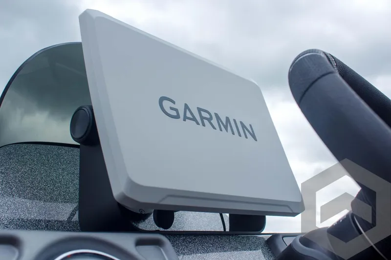 Slide: The Image of Garmin device on 2025 Caymas CX 21 PRO boat dashboard, under cloudy sky. - 41