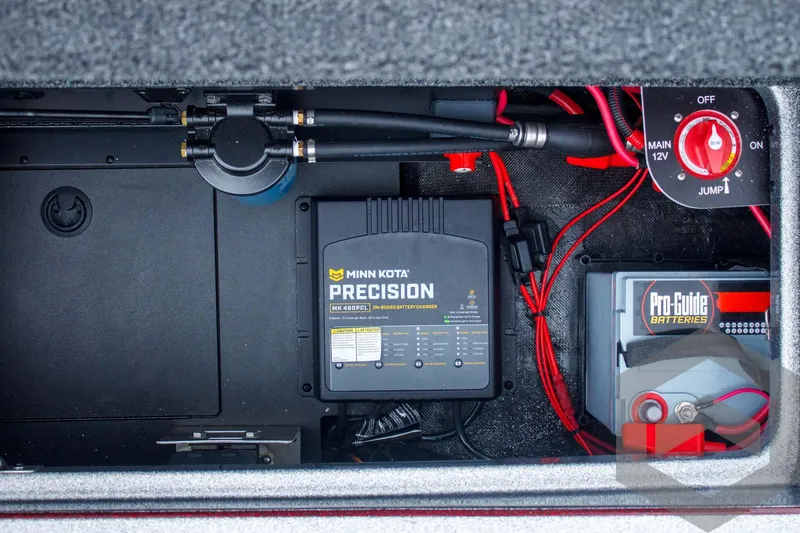 Slide: The Image of 2025 Caymas CX 21 PRO boat battery compartment with Minn Kota Precision charger and Pro-Guide battery. - 49