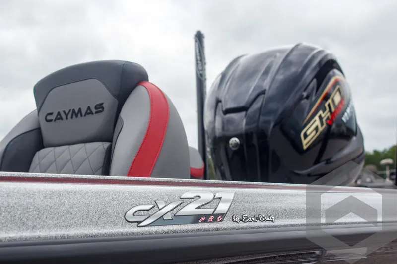 Slide: The Image of 2025 Caymas CX 21 PRO boat interior with branded seat and engine detail. - 9