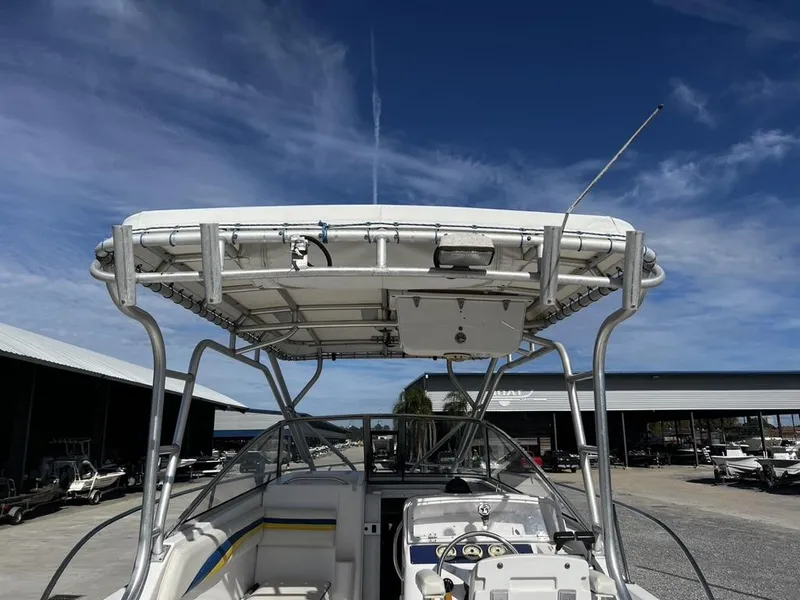 Slide: The Image of 2001 Pro-Line 27 Express boat with T-top, docked under clear blue sky. - 14
