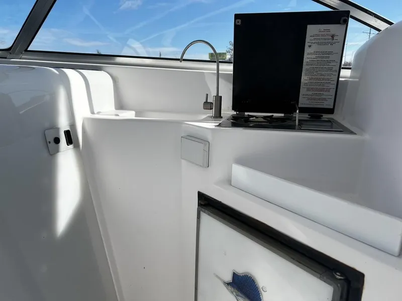 Slide: The Image of 2001 Pro-Line 27 Express boat interior with kitchenette and sink. - 20