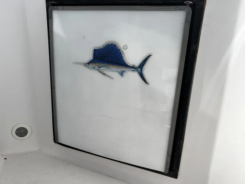 Slide: The Image of 2001 Pro-Line 27 Express boat compartment with a blue marlin emblem. - 22