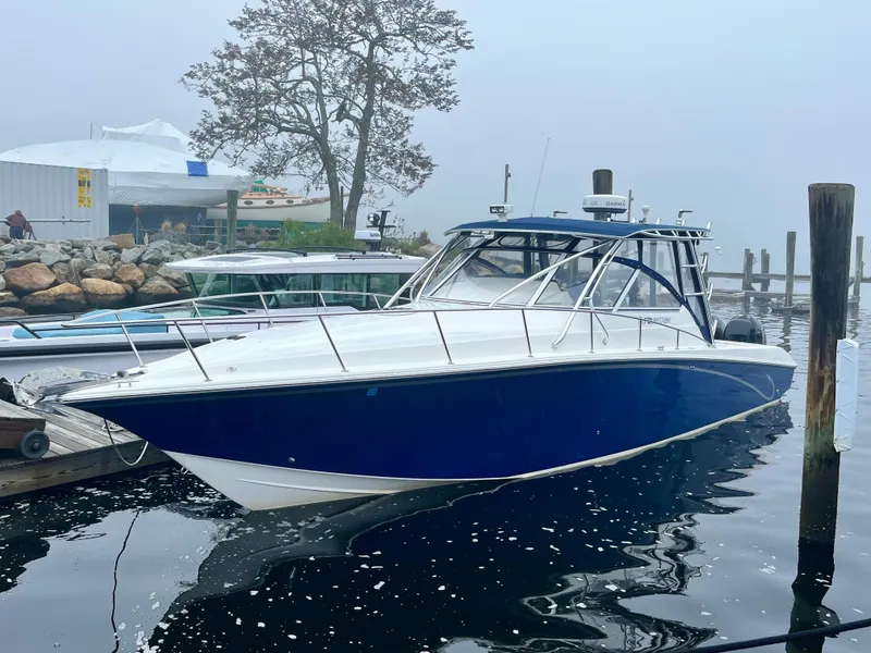 Slide: The Image of 2011 Fountain 38 Sportfish Cruiser docked on a foggy day. - 0