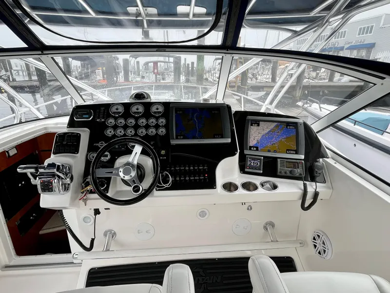 Slide: The Image of Cockpit of 2011 Fountain 38 Sportfish Cruiser with navigation instruments and steering wheel. - 13