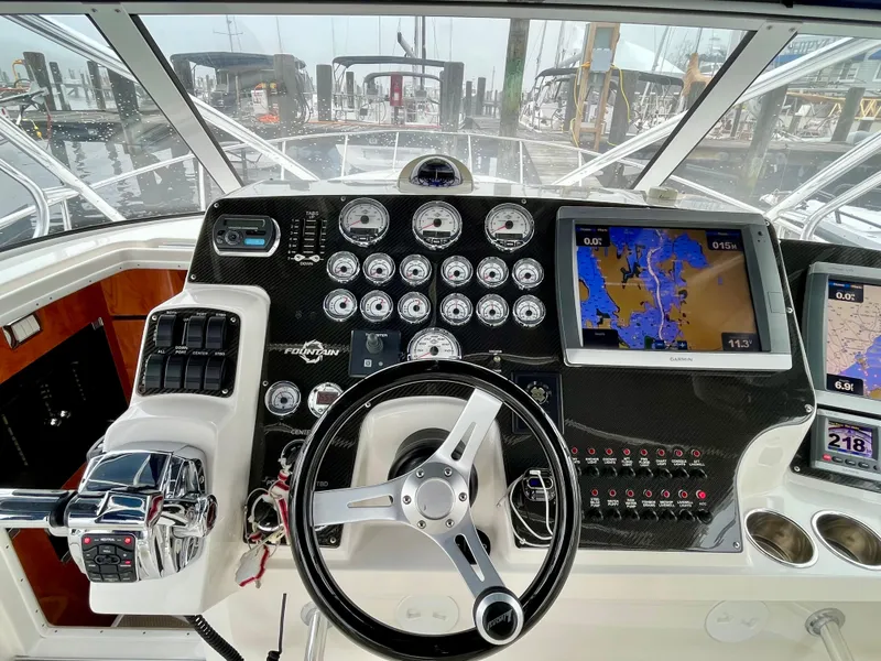 Slide: The Image of Control panel of 2011 Fountain 38 Sportfish Cruiser with navigation screens and gauges. - 14
