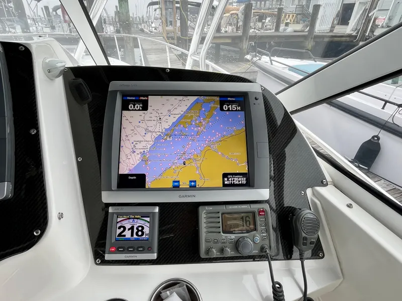 Slide: The Image of Dashboard of a 2011 Fountain 38 Sportfish Cruiser with navigation equipment. - 15