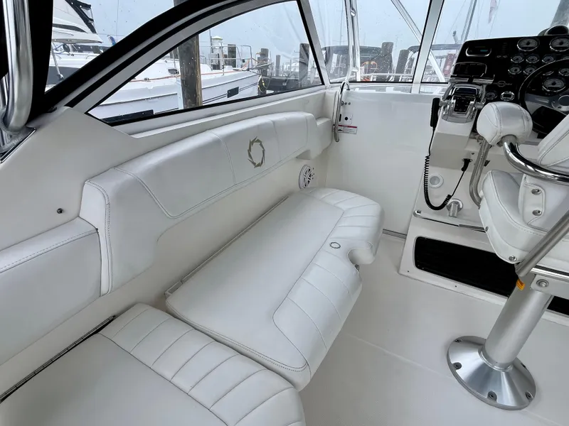 Slide: The Image of 2011 Fountain 38 Sportfish Cruiser interior with white seating and control panel. - 16