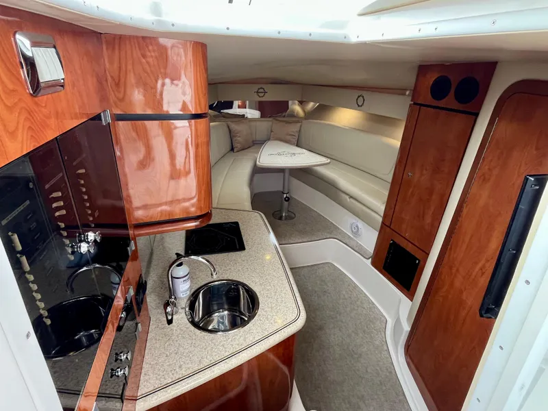 Slide: The Image of 2011 Fountain 38 Sportfish Cruiser interior with kitchenette and seating area. - 22