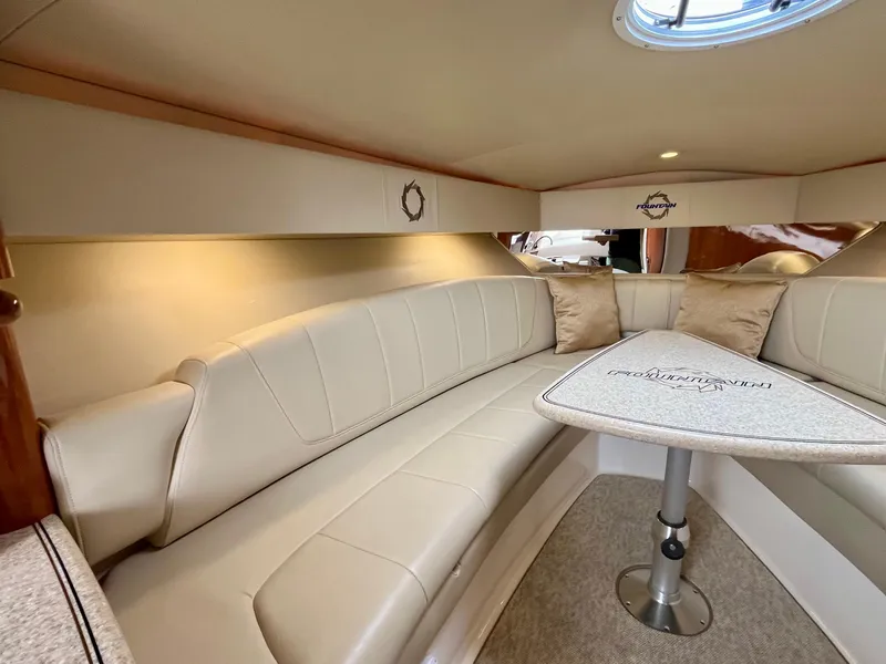 Slide: The Image of Interior of 2011 Fountain 38 Sportfish Cruiser with beige seating and table. - 24