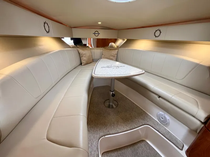 Slide: The Image of 2011 Fountain 38 Sportfish Cruiser interior with beige seating and table. - 25
