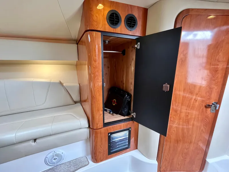 Slide: The Image of Interior of 2011 Fountain 38 Sportfish Cruiser with open wooden cabinet and leather seating. - 29