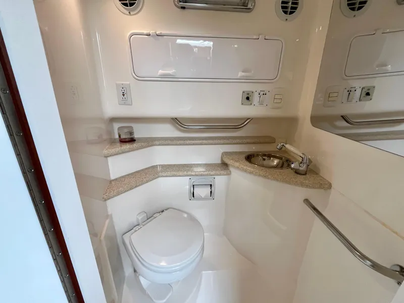 Slide: The Image of 2011 Fountain 38 Sportfish Cruiser bathroom with toilet, sink, and storage compartments. - 31