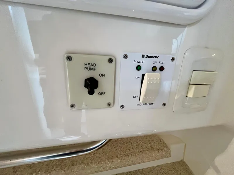 Slide: The Image of Control panel on 2011 Fountain 38 Sportfish Cruiser with head and vacuum pump switches. - 32