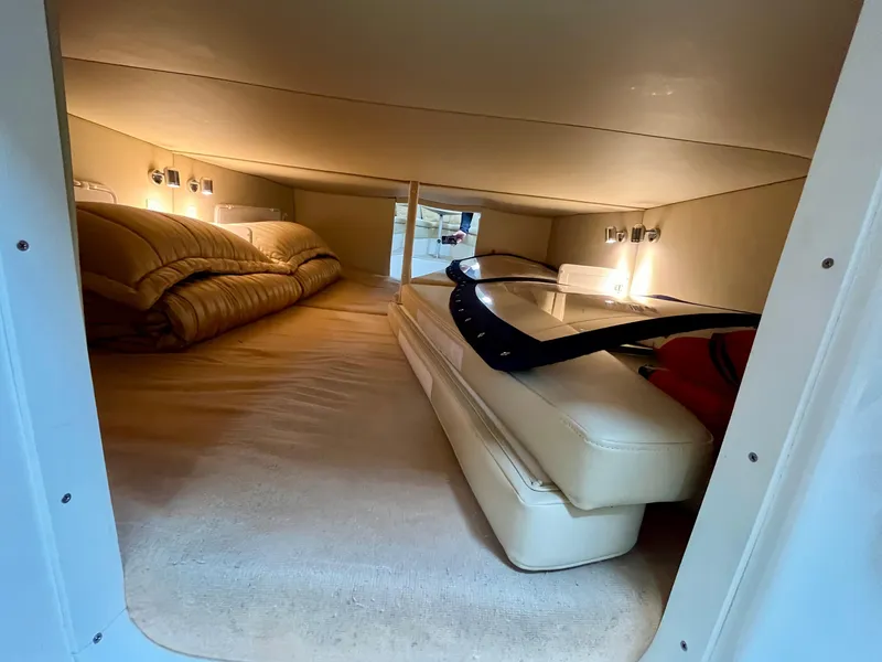 Slide: The Image of 2011 Fountain 38 Sportfish Cruiser cabin interior with cozy bedding and ambient lighting. - 35