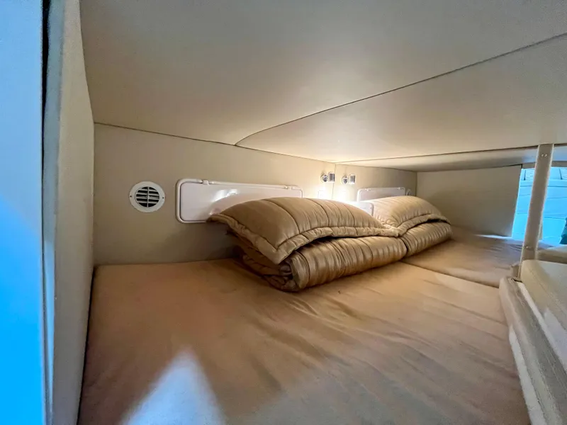 Slide: The Image of Cozy cabin interior of 2011 Fountain 38 Sportfish Cruiser with beige bedding. - 36