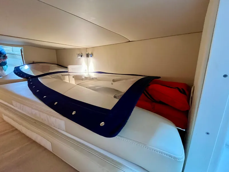 Slide: The Image of 2011 Fountain 38 Sportfish Cruiser cabin interior with bed and storage. - 37