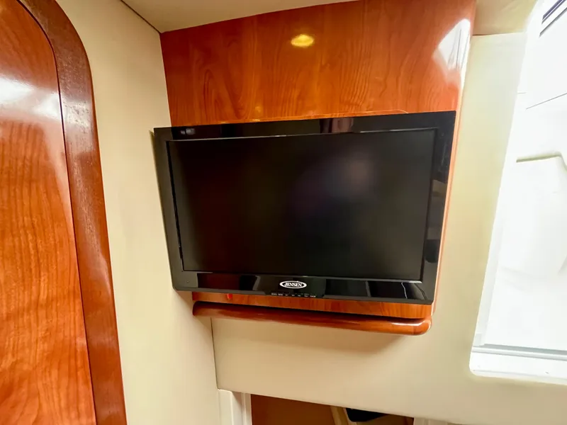 Slide: The Image of Flat-screen TV mounted on wood panel inside 2011 Fountain 38 Sportfish Cruiser. - 38
