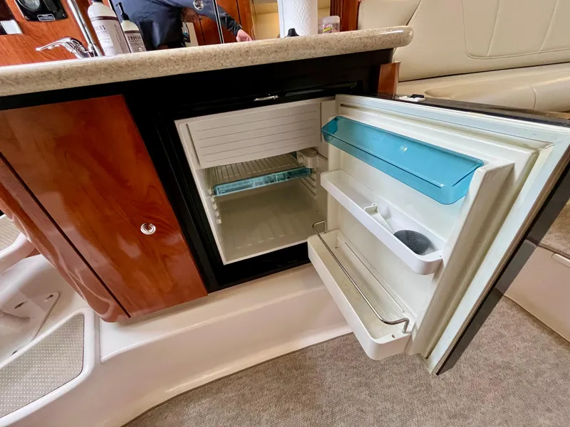 Slide: The Image of Open mini fridge inside 2011 Fountain 38 Sportfish Cruiser yacht interior. - 40