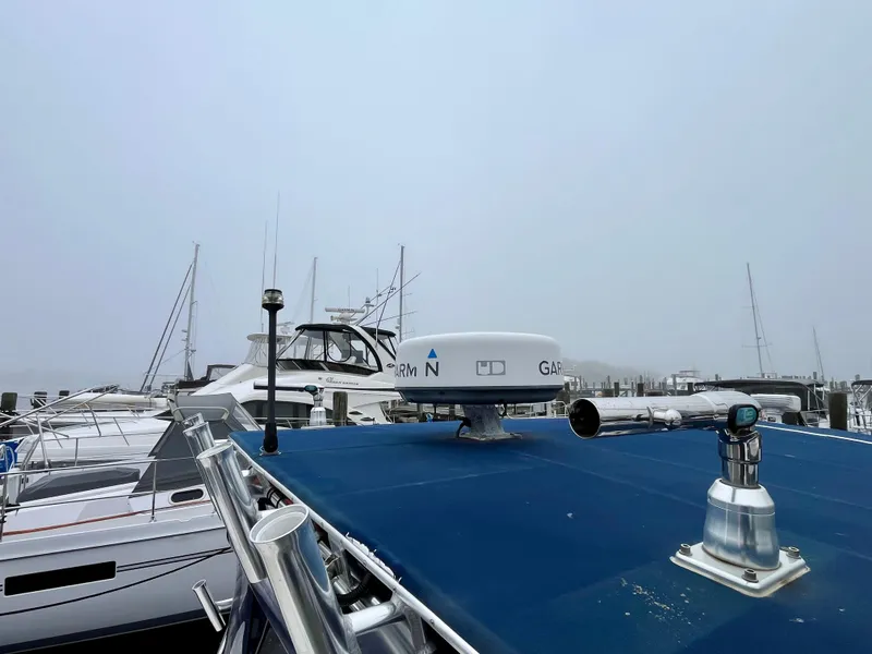 Slide: The Image of 2011 Fountain 38 Sportfish Cruiser docked with radar equipment on a foggy day. - 47