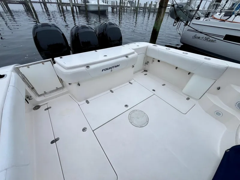 Slide: The Image of 2011 Fountain 38 Sportfish Cruiser boat deck with triple outboard motors at marina. - 6