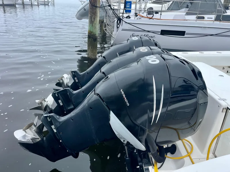 Slide: The Image of Triple outboard motors on a 2011 Fountain 38 Sportfish Cruiser at a marina. - 7
