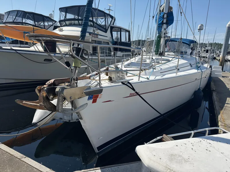 The Image of 1997 Beneteau 50 sailboat docked at marina, surrounded by other boats. - 0