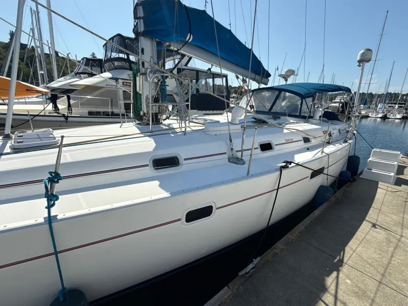 Slide: The Image of Sailboat docked at marina, 1997 Beneteau 50 with blue canopy and white hull. - 12