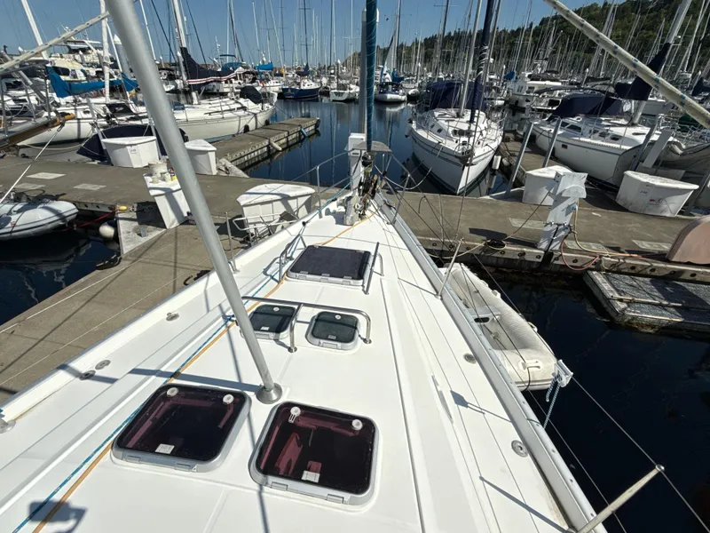 Slide: The Image of Deck view of a 1997 Beneteau 50 sailboat docked in a marina. - 13