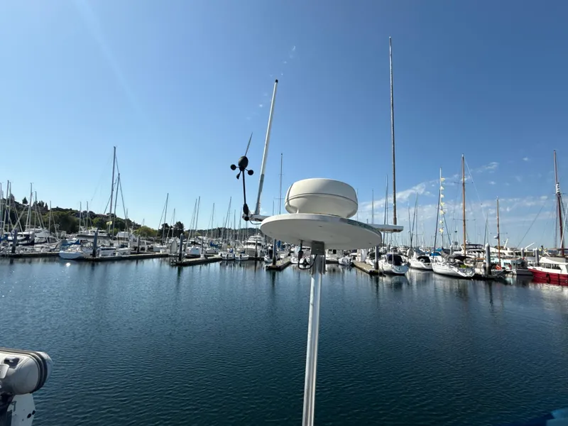 Slide: The Image of Marina view with sailboats, featuring a 1997 Beneteau 50 under clear blue skies. - 16