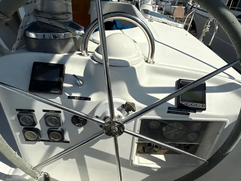 Slide: The Image of Steering wheel and controls of a 1997 Beneteau 50 sailboat cockpit. - 21