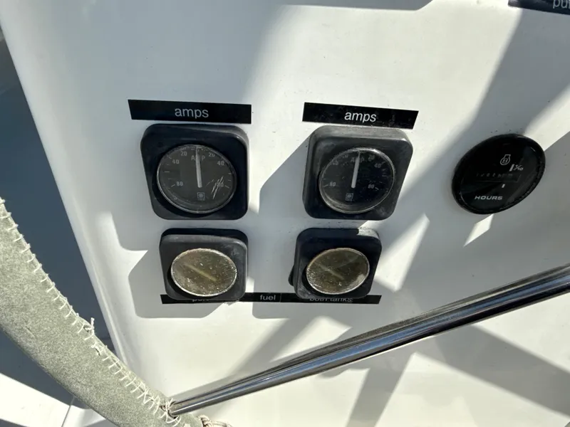 Slide: The Image of Control panel of a 1997 Beneteau 50 yacht, displaying amp and fuel gauges. - 24
