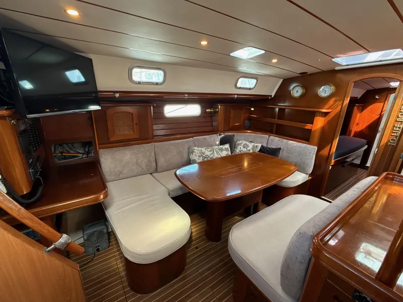 Slide: The Image of Luxurious interior of a 1997 Beneteau 50 yacht with cozy seating and elegant wood finish. - 29
