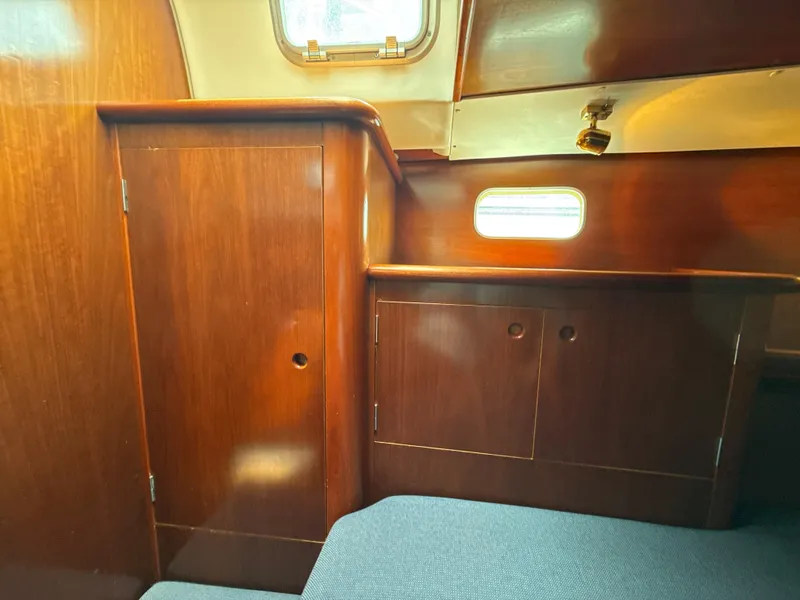 Slide: The Image of Interior of 1997 Beneteau 50 yacht with wooden cabinetry and small window. - 38
