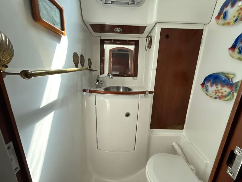 Slide: The Image of Bathroom interior of a 1997 Beneteau 50 yacht with sink and nautical decor. - 40
