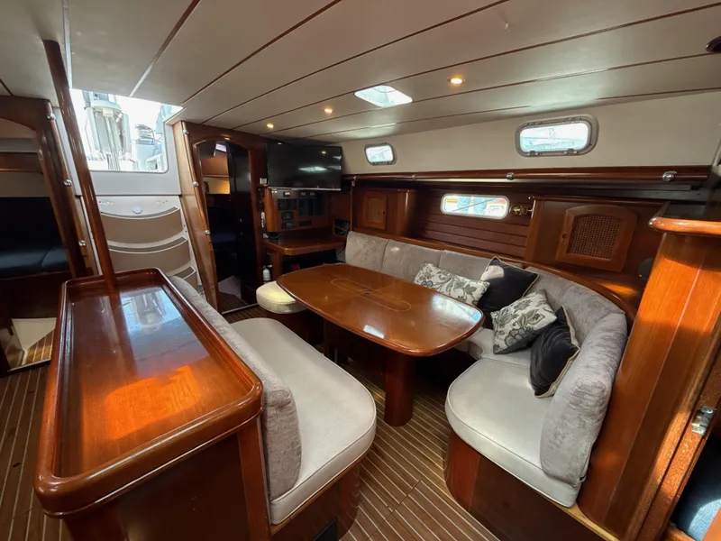 Slide: The Image of Luxurious interior of a 1997 Beneteau 50 yacht with elegant wood finishes and cozy seating. - 41