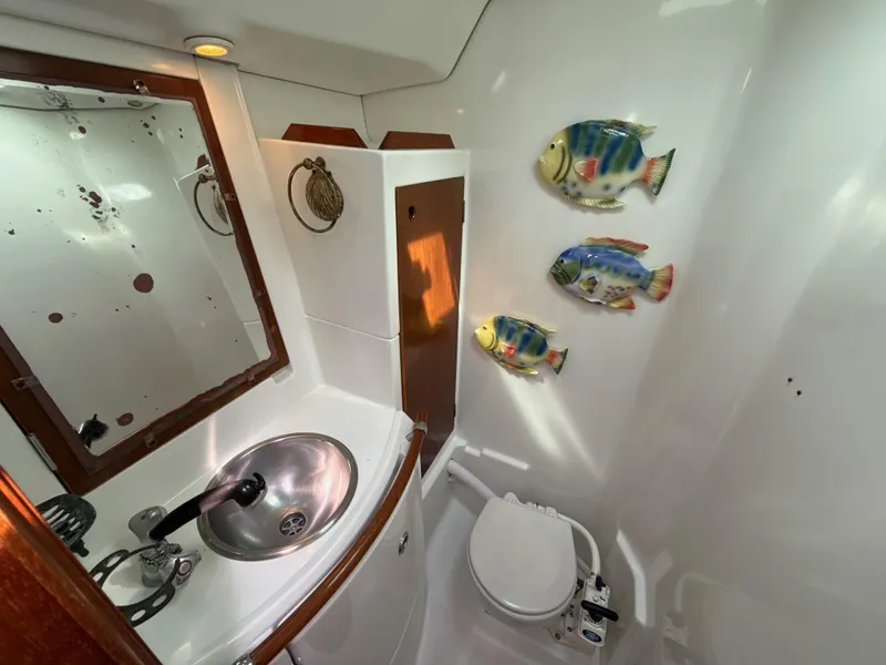 Slide: The Image of Bathroom interior of 1997 Beneteau 50 yacht with fish decor and compact fixtures. - 48