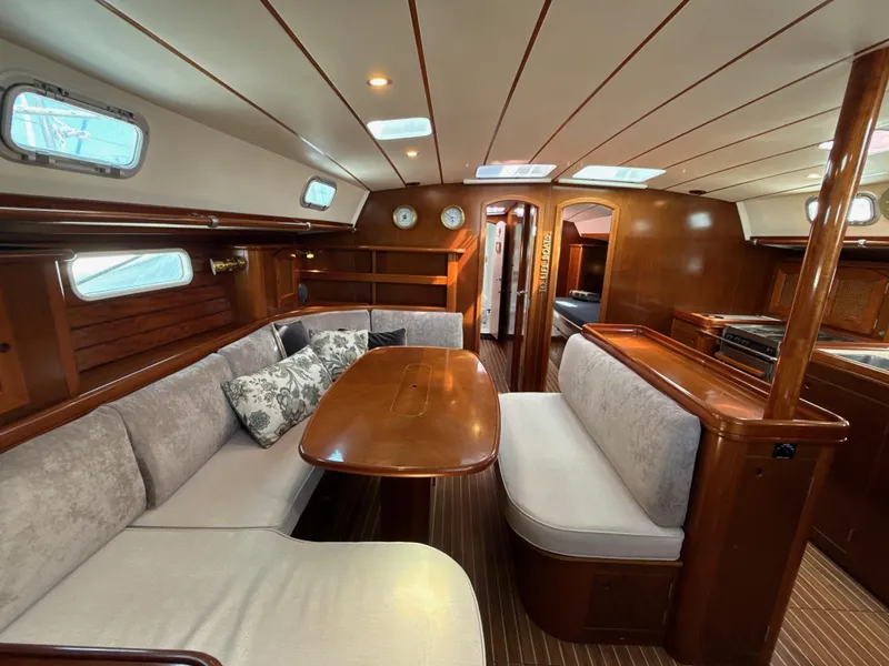 Slide: The Image of Luxurious interior of a 1997 Beneteau 50 yacht with elegant wood finishes and cozy seating. - 5