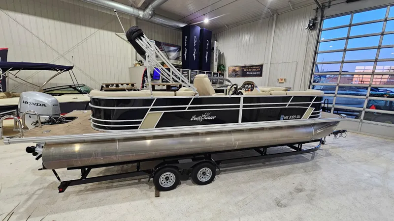 Slide: The Image of 2019 SunChaser Eclipse 8525 Entertainer pontoon boat on trailer in showroom. - 1